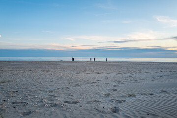 people walking on the beach