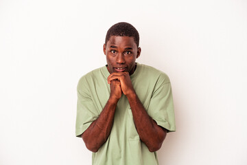 Young African American man isolated on white background praying for luck, amazed and opening mouth looking to front.