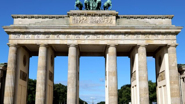 Brandenburg Gate (German: Brandenburger Tor) in city of Berlin, Germany. Neoclassical style iconic city landmark from 1791, tilt up shot.
