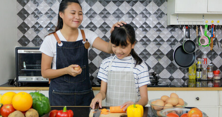 Asian family is enjoying cooking in the kitchen at home.