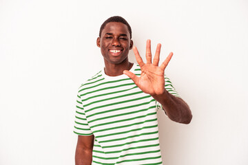 Young African American man isolated on white background smiling cheerful showing number five with fingers.