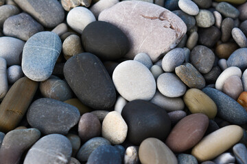 Multicolored colorful sea pebbles, natural background, texture. Close-up texture of colorful sea pebbles. Small Rock. Sea background