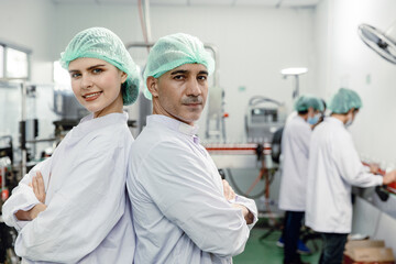 Obraz premium Portrait team worker staff labor working in food factory standing looking camera happy smile.