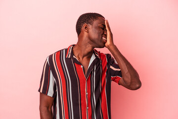 Young African American man isolated on pink background laughing happy, carefree, natural emotion.