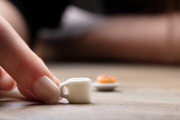hands with mini food on a table