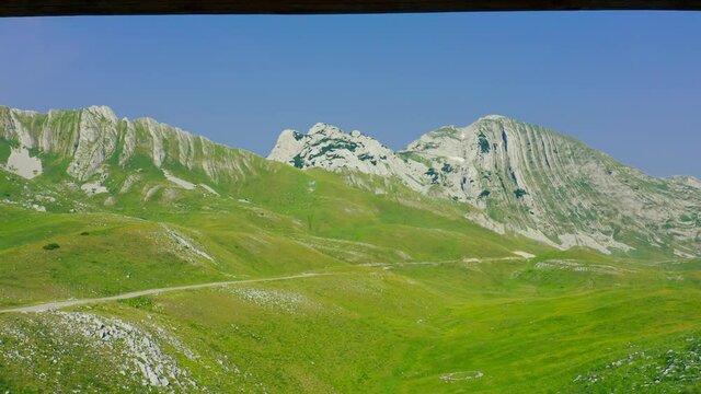 Beautiful couple sit in Mountain Prutas at National Park Durmitor, Montenegro. Lifestyle and travel.