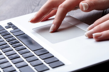 detail of perfectly manicured hands on laptop keyboard