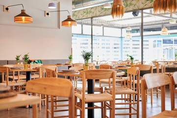 empty restaurant of rustic design with wooden furnishings ready to open
