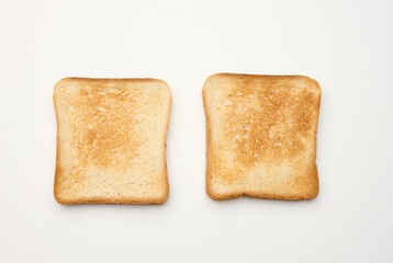 square slices of bread made from white wheat flour toasted in toaster, top view