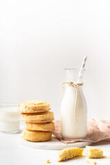 Freshly baked homemade honey cookies with milk for breakfast on a white background