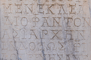 Ancient Greek inscriptions on stone in archeological ruin in ancient Greece site - design,...
