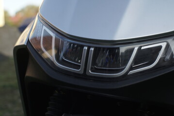 Obraz premium A Headlight Of A Grey Scooter