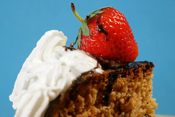 Delicious strawberry cake with cream and chocolate, tart with fresh strawberries on wooden...