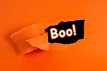 Torn hole paper orange color with copy space for text halloween