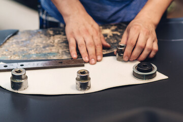 Handmade leather craftsman. Worker sewing leather product. Leather worker workshop. Working process of sewing car seat cover.