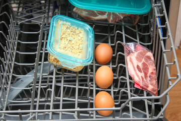 Dishwasher cooking. Alternative use of the dishwasher. Cooking meat, eggs, fish, vegetables at low...