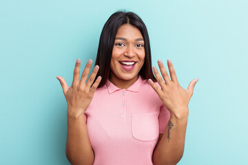 Young Venezuelan woman isolated on blue background showing number ten with hands.