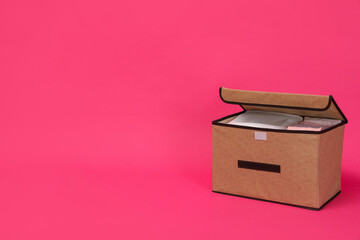 Textile storage case on pink background. Space for text