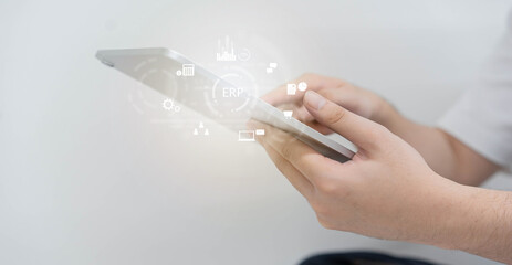 close up employee man hand hold digital let and using ERP program application to connect with team or check system for future business and data development concept