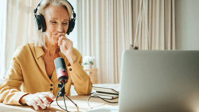 Stylish Mature Woman At Her Cozy Home Apartment. Happy Audio Podcasting With Her Audience