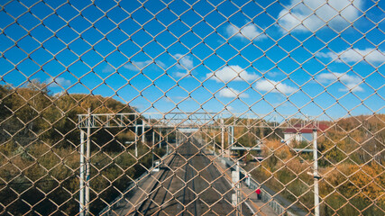 lattice behind which you can see the forest and the railway