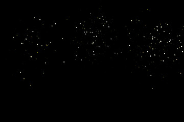 White glowing small splashes on a black background. Falling sparkling snow on a black background