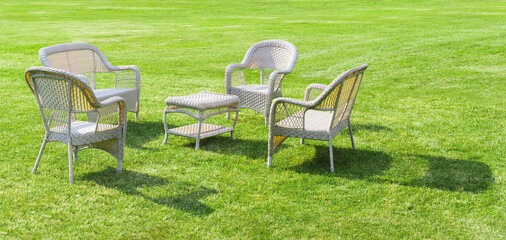 Obraz na płótnie Canvas Open air restaurant with wood chairs on green grass. Outdoor garden furniture