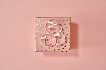 Christmas present in a pink gift box - minimalist Christmas concept