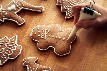 Decoration of a homemade gingerbread Christmas cookie with icing