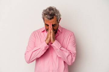 Middle age caucasian man isolated on white background  praying, showing devotion, religious person...