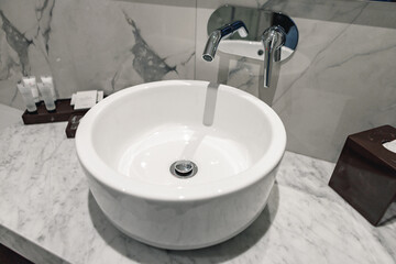 Luxury white porcelain sink on a bathroom table in hotel
