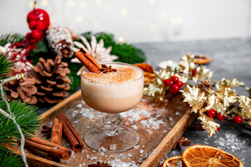 A glass of traditional Christmas drink eggnog on a festive table, copy space for text. Spicy drink...