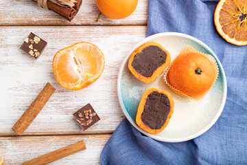 Truffle chocolate tangerine candies on a white wooden background. top view, close up.
