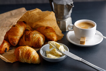 Morning breakfast with croissants. Breakfast table with croissants and coffee, on a marble stone table.