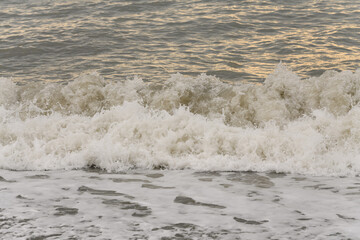 white sea foam near the shore close-up, waves
