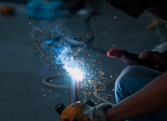 Industrial Worker welding steel - welder works in metal construction - construction and processing of steel components