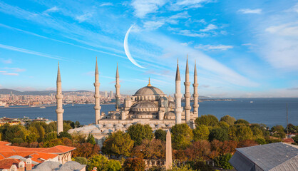 Fototapeta na wymiar The Blue Mosque with amazing white clouds and crescent (new moon) - Istanbul, Turkey.