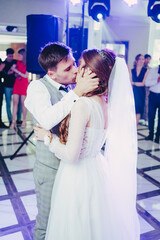The bride and groom kiss