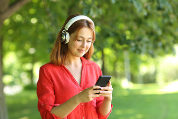 Happy woman in red listening to music on smartphone