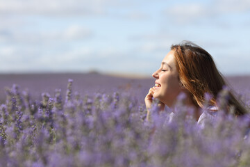 Woman relaxing in the middle of lavender field