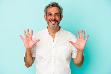 Middle age caucasian man isolated on blue background  showing number ten with hands.