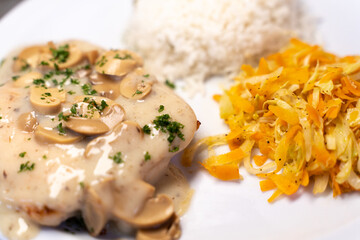 Close up photo of mixed dish of rice with meat accompanied by mushroom sauce