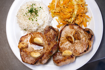 Aerial photo of a grilled meat with white rice and vegetables