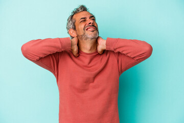 Middle age caucasian man isolated on blue background  suffering neck pain due to sedentary lifestyle.