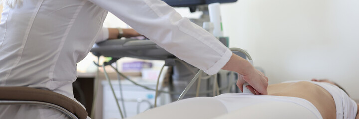 Doctor making ultrasound examination of pelvic organs to woman patient closeup