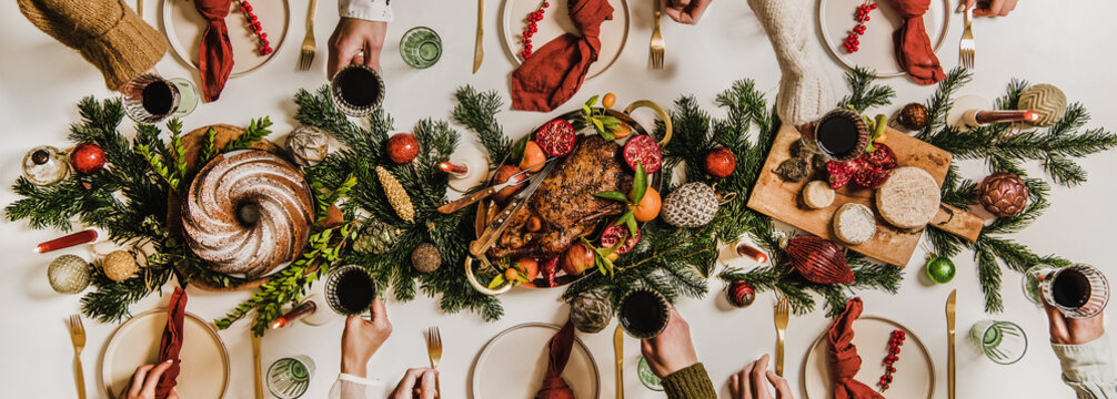 Flat-lay Of Festive Christmas Table Setting And Celebrating People Hands