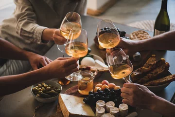 Foto auf Leinwand Friends having wine tasting or celebrating event with wine © sonyakamoz