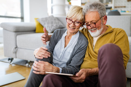 Retired happy senior couple spending time together with tablet. Technology people concept