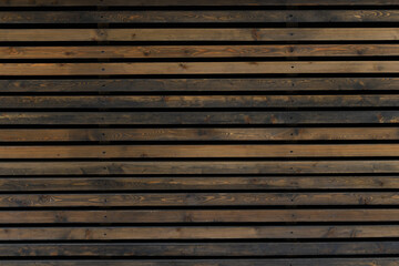 Wooden background of brown boards. Horizontal wooden slats. The texture of the wooden wall. Narrow...