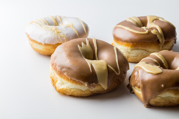 Glazed donuts with chocolate, vanilla and caramel frosting - rustic style delicious dougnut...